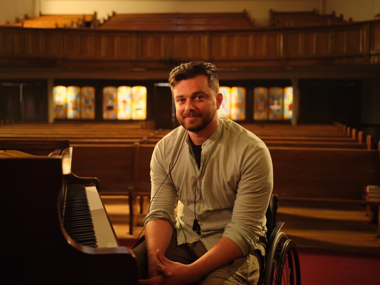 Riccardo seated at the piano